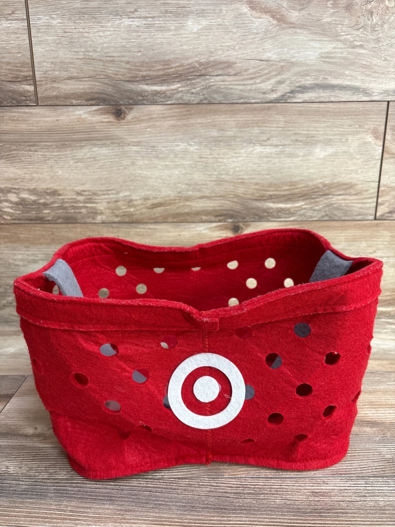 Red felt Target-themed storage basket with white bullseye logo and polka dots, ideal for kids' toys or baby gear organization.