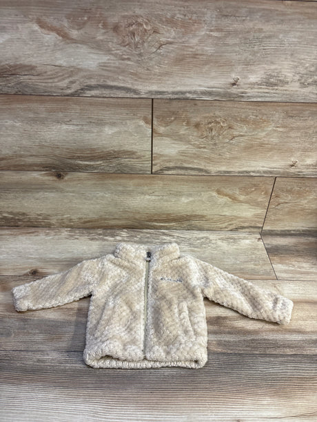 Front view of Columbia Fire Side Sherpa jacket with beige sherpa fabric, full zip and logo on wood background size 3-6mo