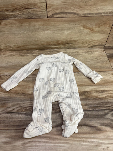 Top view of Just One You ivory ribbed kimono sleeper with long sleeves, footed legs, and animal pattern on a wood-look floor