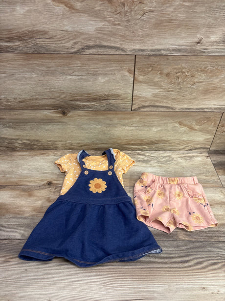 Front view of Pekkle three-piece skirtall set with navy skirtall, yellow patterned shirt, and pink floral shorts on a wood floor