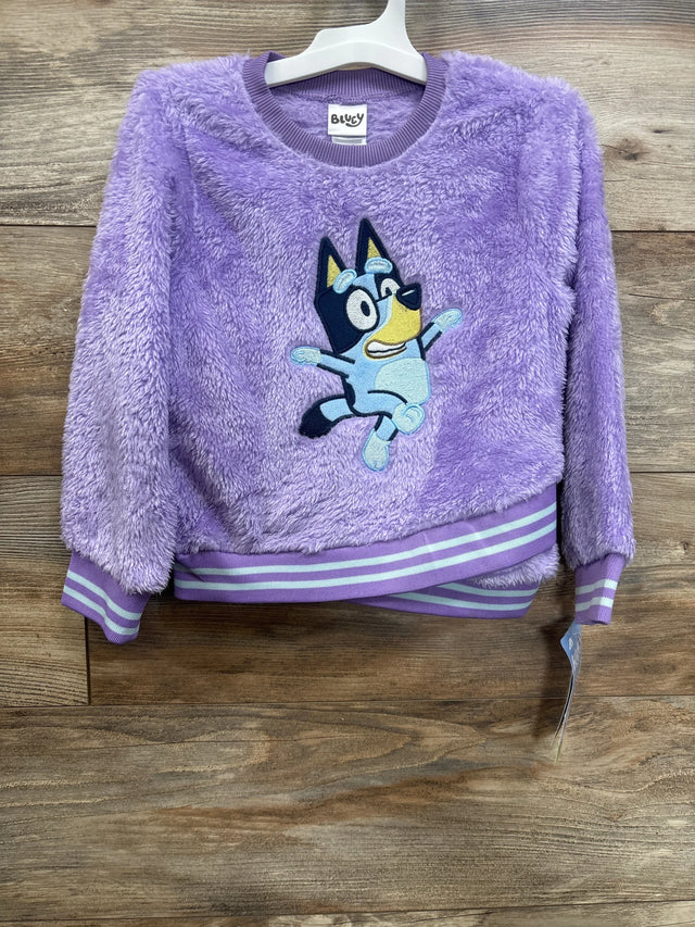 Purple fuzzy kids sweatshirt with cartoon dog graphic, striped cuffs and hem, on hanger