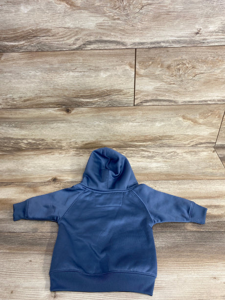 Back view of a navy blue toddler hoodie laid flat on a wooden floor background