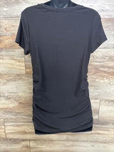 Back view of black maternity shirt with ruched sides and short sleeves on a mannequin against wood background