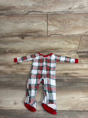 Red green plaid baby footed pajamas on wood floor, holiday kids sleepwear