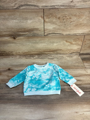 Blue tie-dye baby long sleeve shirt with tag, displayed on wooden floor