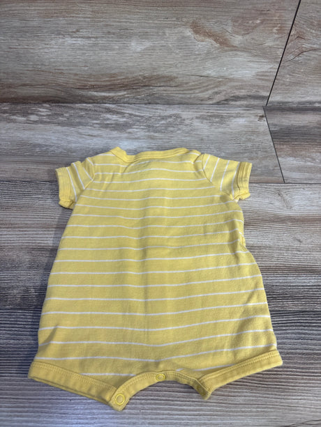 Back view of Carter's shortie romper in yellow with white stripes, short sleeves and snap crotch laid flat on light wood floor
