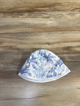 Top-down view of Janie & Jack bucket hat, size 0-3M, showing blue palm print on white fabric on wood background
