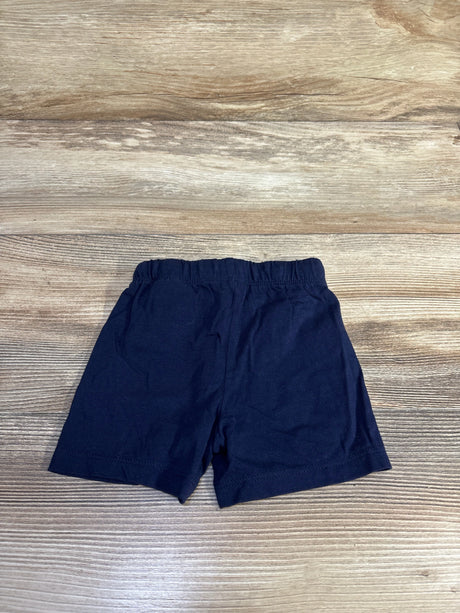 Flat lay of navy H&M baby pull on drawstring shorts size 6 months showing elastic waistband on wood background
