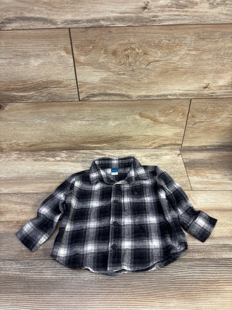Front view of grey and black plaid toddler button-up flannel shirt showing collar, chest pocket, and buttons on wood background