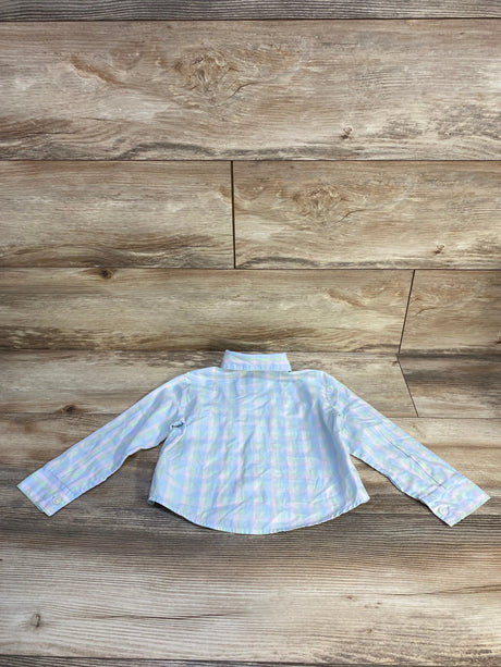 Back view of toddler blue plaid Tommy Hilfiger long-sleeve button-up shirt laid flat on wood plank background