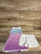Flat-lay of girls purple ombre tennis dress with white side panels and matching white elastic-waist shorts on wood floor