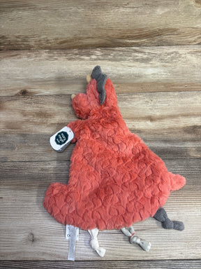 Soft orange plush animal lovey toy with knotted limbs on wood background