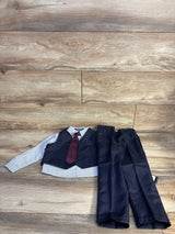 Flat lay of boys' 4-piece navy suit (4T) showing striped shirt, navy vest with red paisley tie and navy pants on wood