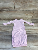 Light pink long sleeve baby gown with elastic hem on wood background