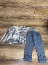 Blue and white striped long sleeve baby top with matching blue ruffle leggings on wood floor