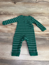 Green and white striped long-sleeve baby romper on wooden floor, kids clothing