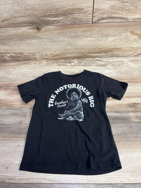 Black toddler T-shirt with white graphic of baby and text The Notorious B.I.G. Brooklyn's Finest '94 on wood floor