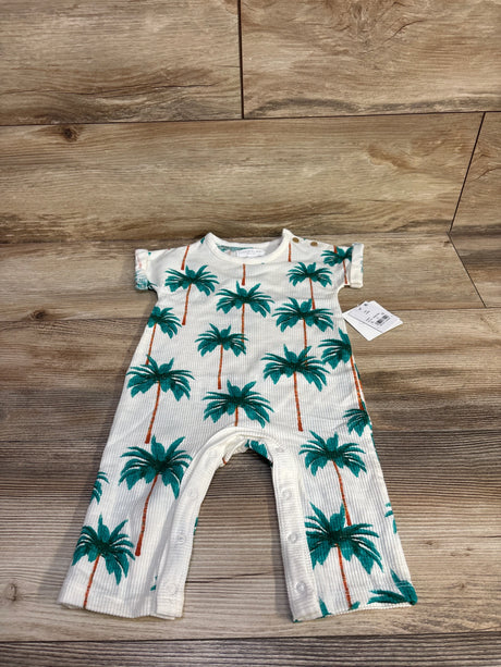 Front flat-lay of Grayson Mini ribbed baby jumpsuit with green palm print, shoulder snaps and snap leg closure on wood