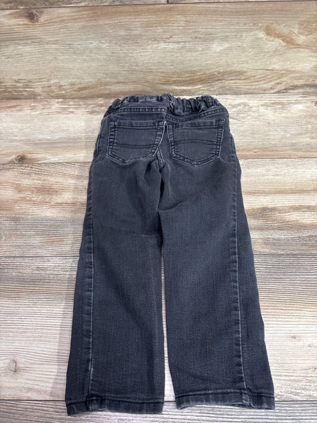 Back view of Children’s Place skinny jeans in Grey, size 3T, showcasing elastic waist and back pockets on a wood grain surface