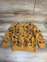 Yellow kids sweatshirt with navy sports ball and captain print, long sleeves, on wood background