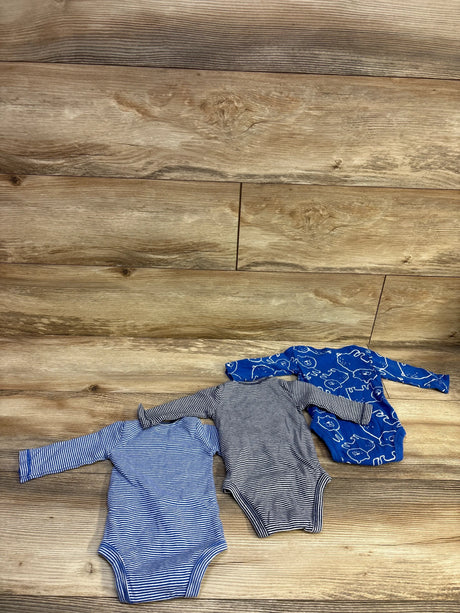 Carter's 3-pack of blue baby bodysuits in stripes and prints on a wooden background