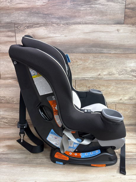 Angled view of Graco Extend2Fit convertible car seat in Gotham showcasing cup holders and adjustable base with wood-paneled background
