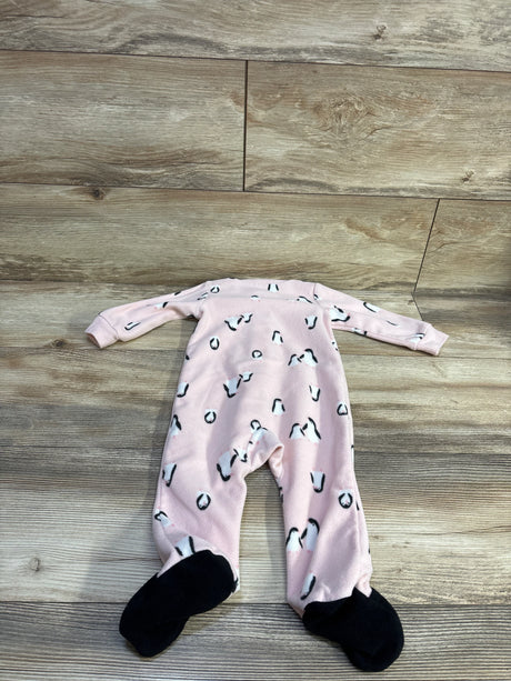 Flat-lay of Carter’s pink 9-month blanket sleeper showing penguin print and black footed soles on wood floor