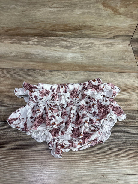 Top view of Kate Quinn bamboo ruffle bloomers in white with pink floral print and layered ruffles on a wood background