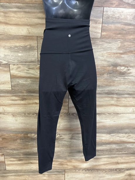 Front flat view of CRZ Yoga cropped maternity leggings showing high fold-over waistband and cropped legs on wood floor background