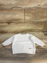 White long sleeve knit baby sweater on wood background, gently used kids clothing