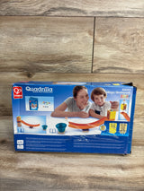 Front view of Hape Quadrilla Mega Skatepark wooden marble-run playset box showing illustrated parent and child, orange curved tracks, and blue bowls on wood floor background