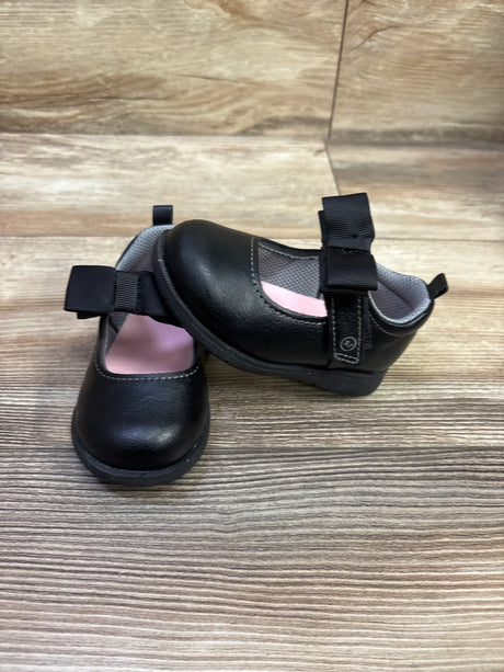 Top and side view of black Stride Rite 360 Hazel Mary Jane flats showing Mary Jane straps and pink lining on a wood-grain surface