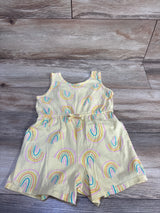 Front flat-lay of yellow Old Navy sleeveless shortie romper showcasing rainbow print and tied elastic waist on wood background