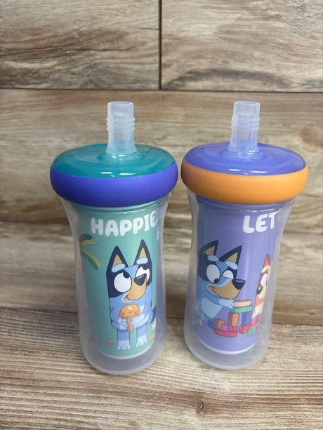 Front view of The First Years Bluey insulated straw cups showing two 9oz cups with Bluey character art and translucent shells on wood