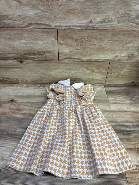 Front view of Janie & Jack houndstooth ruffle dress in butterscotch, showing a full skirt and white collar on a wood floor
