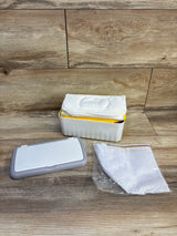 Front view of Famoplay baby wipe dispenser with 54 reusable white flannel wipes, gray lid, and mesh bag on wood background