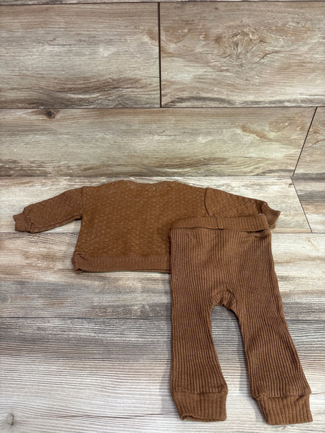 Top-down view of RZ by Rachel Zoe 2pc sweatshirt and ribbed pants set in brown, showcasing ribbed pants on wood-look floor