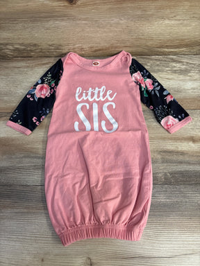 Flat-lay of pink baby gown size 3-6M with black floral long sleeves, white little SIS text, and elastic gathered hem on wood background