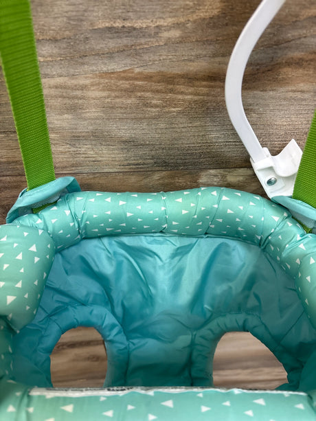 Close-up view of Evenflo Exersaucer Door Jumper showcasing teal padded seat, green straps, and white frame on a wood background