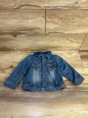 Blue denim toddler jacket with buttons and front pockets on wood floor background