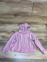 Pink Juicy Couture kids hoodie with logo print, laid on wood floor