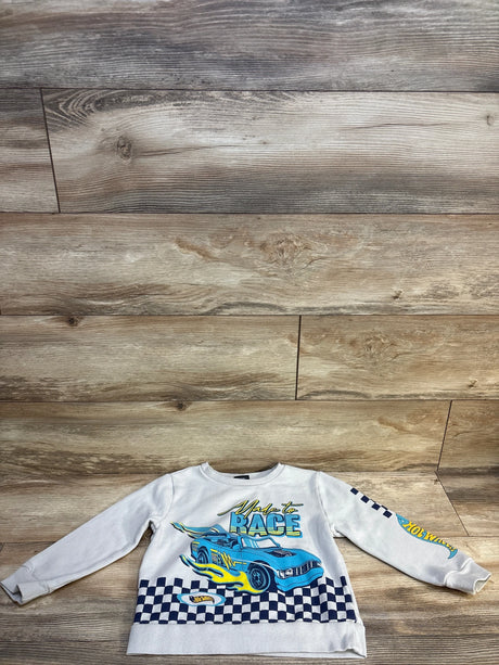 Kids Hot Wheels sweatshirt with blue race car graphic and checkered pattern on wooden floor.