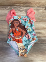 Front view of toddler one-piece Moana swimsuit with large Moana print, aqua floral background and coral ruffle sleeves on wood