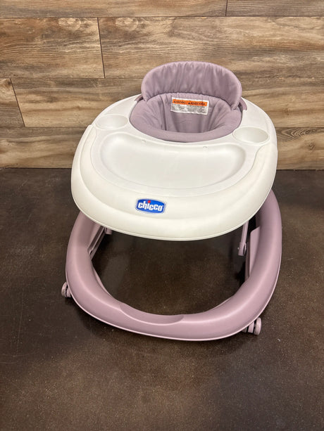 Front view of Chicco Mod walker in lavender showcasing padded seat, tray, cup holders, and wheels with wood floor background