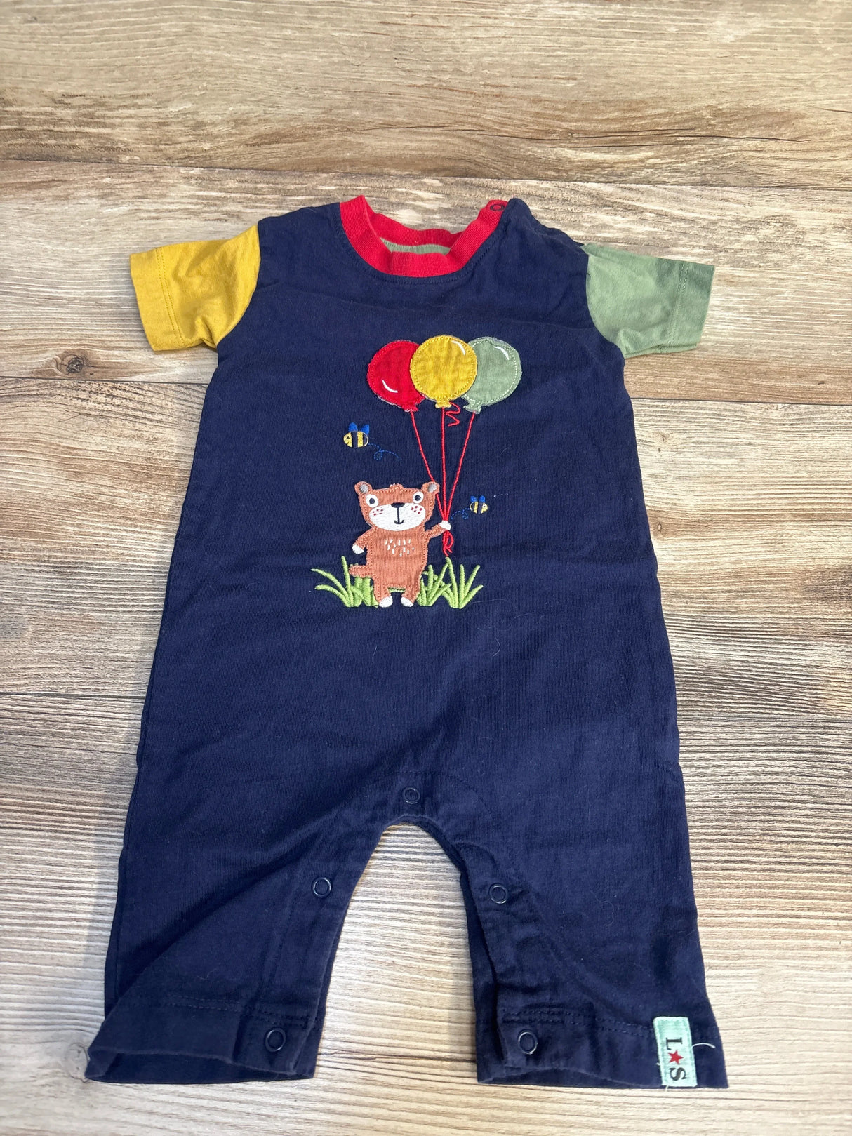 Navy blue baby romper with colorful bear and balloons design, yellow and green sleeves