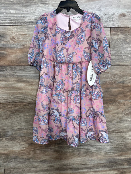 Front view of dusty rose paisley tiered girls' dress with puff sleeves, gathered tiers and visible 4T tag on wood background