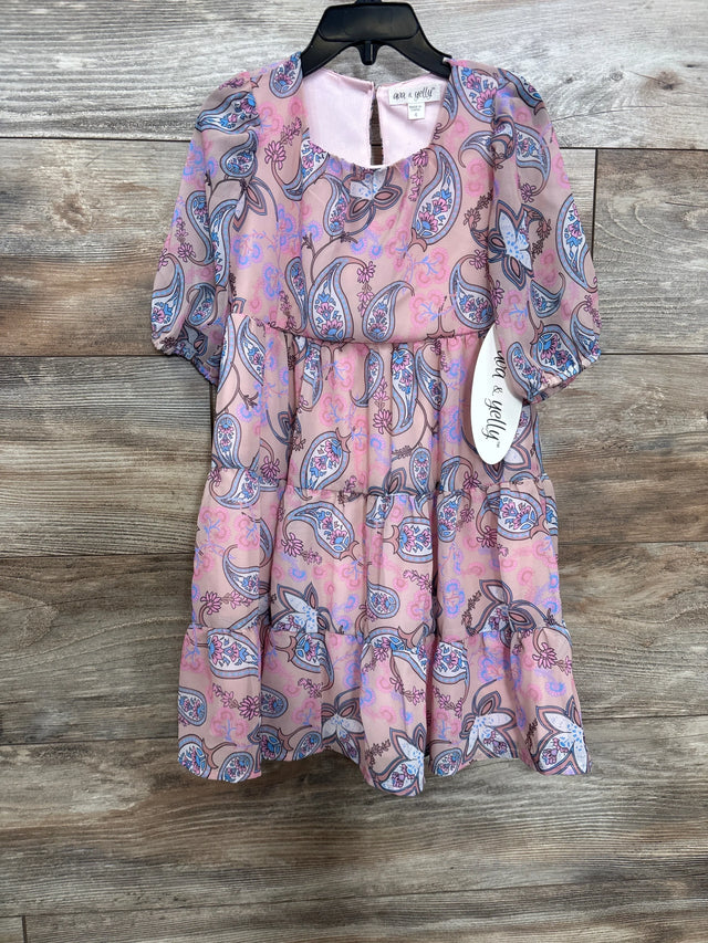 Front view of dusty rose paisley tiered girls' dress with puff sleeves, gathered tiers and visible 4T tag on wood background