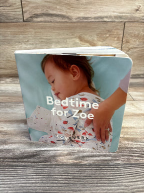Front view of Lovevery 'Bedtime for Zoe' board book showcasing personalized cover with child in floral pajamas on wood floor