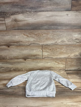 Light gray kids crewneck sweatshirt laid flat on wood floor background