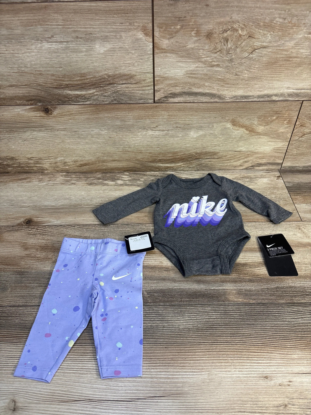 Nike baby 2-piece set with gray bodysuit and purple polka dot leggings
